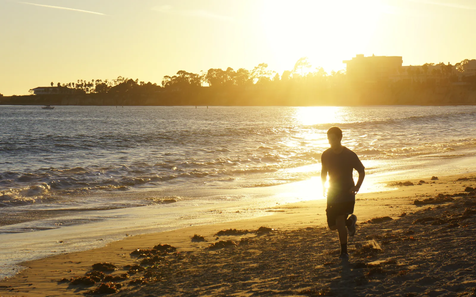 Sunset at Goleta Beach, California, showing the sandy shore and Pacific Ocean horizon
